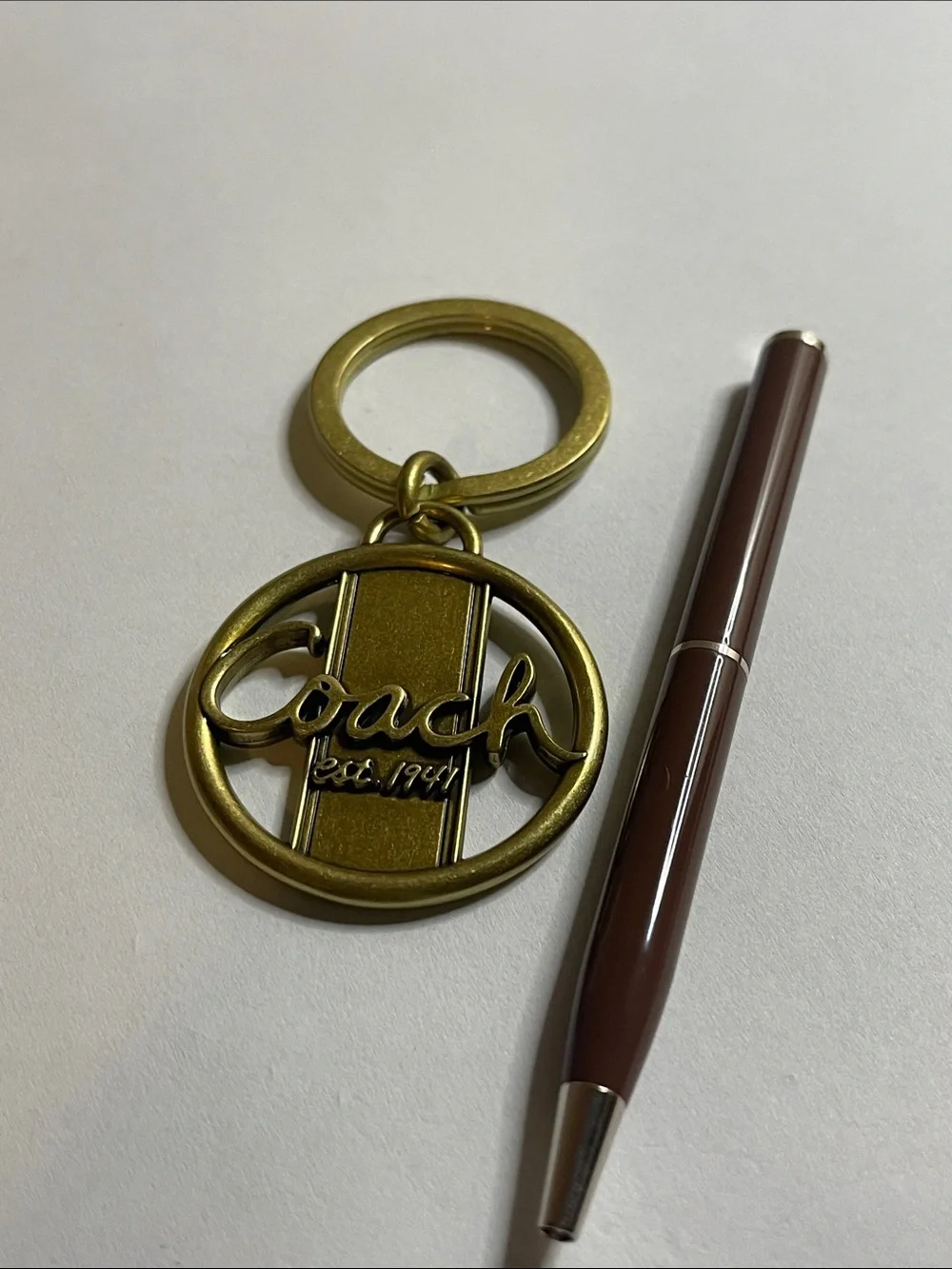 Coach Gold-Tone Circular Logo Keyring and Coach Pen